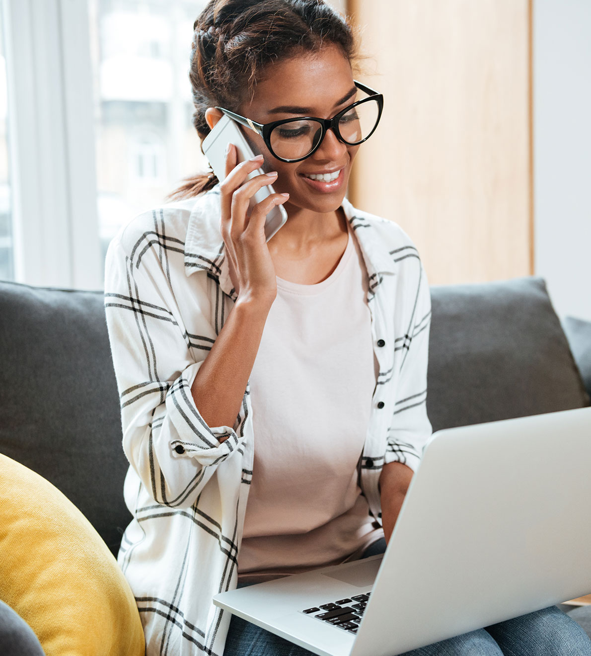 Woman on computer speaking on phone The smart communications provider for UK businesses. Woman on computer speaking on phone